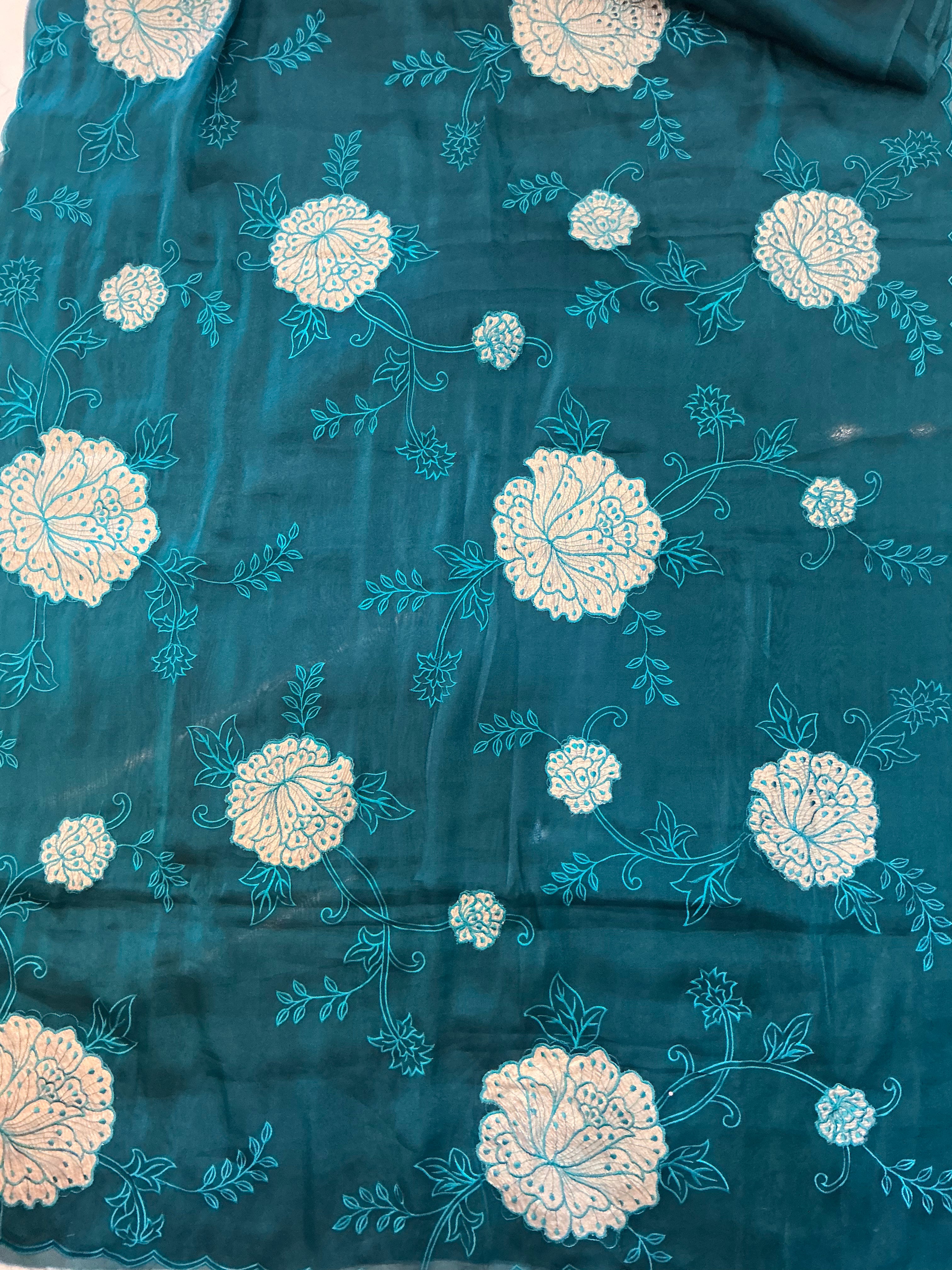 The Midnight Bloom: Peacock Blue Sheer Crush Organza Saree with Elegant Floral Medallions