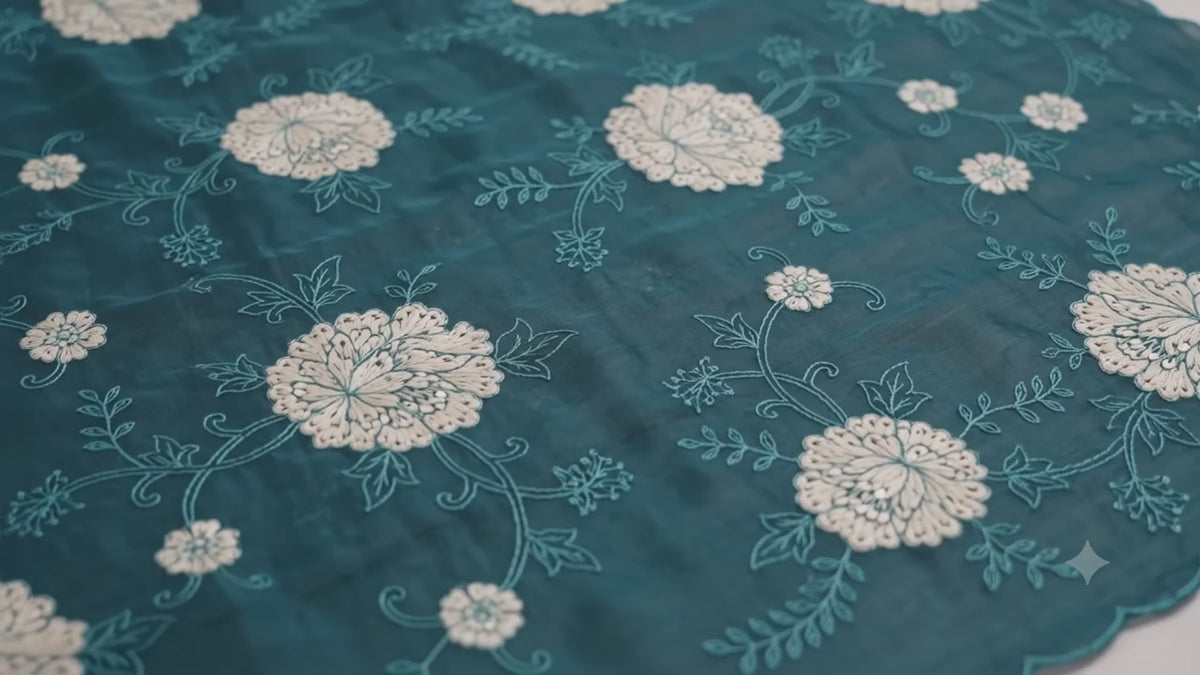 The Midnight Bloom: Peacock Blue Sheer Crush Organza Saree with Elegant Floral Medallions